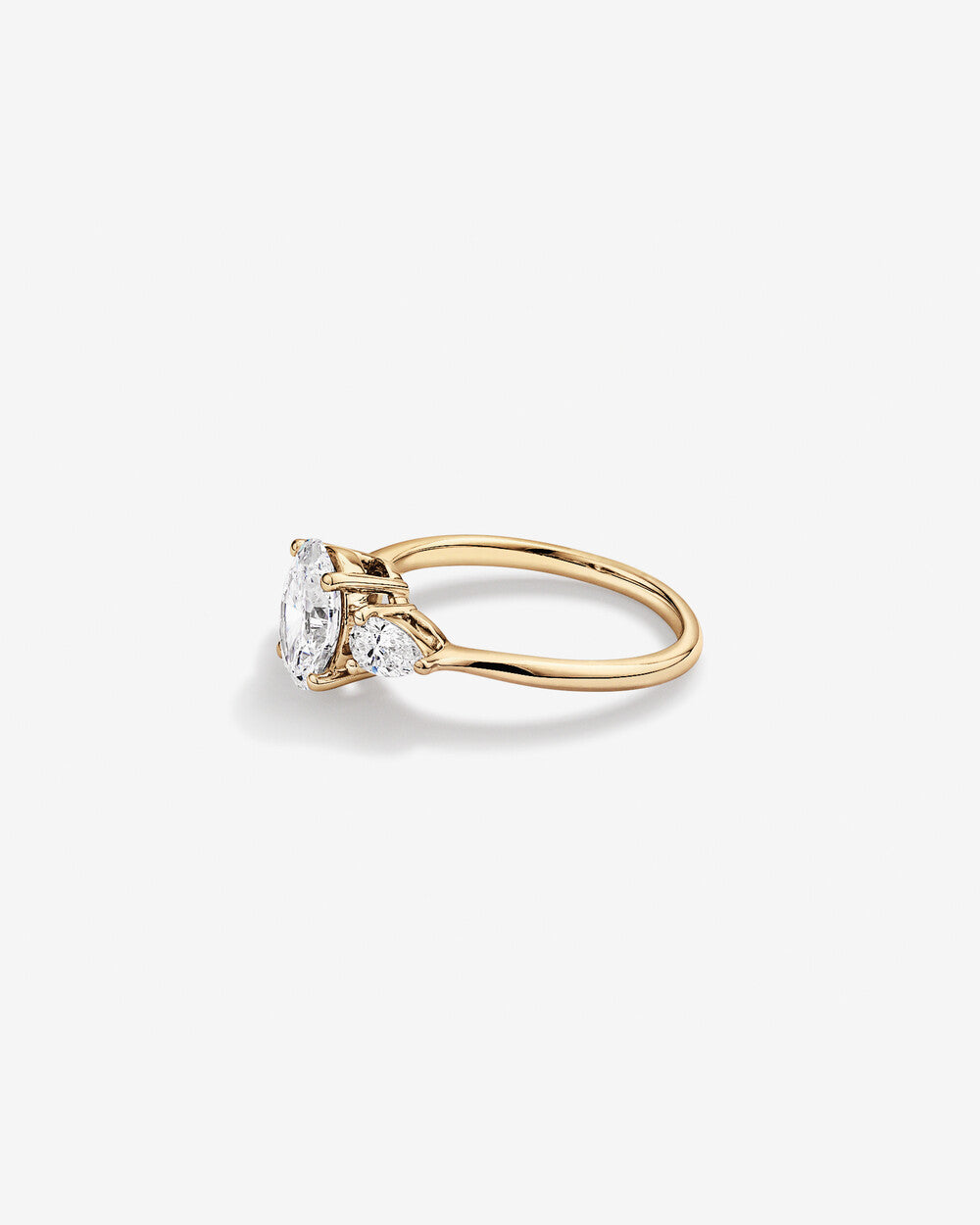 Oval Diamond Ring with Pear Side Stones in Yellow Gold